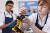 Student working on robotic device in vocational class