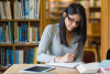 female student studying in library (shutterstock)