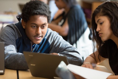 A ninth-grade student explains a new algebraic concept to his classmate. Photo by Allison Shelley/The Verbatim Agency for American Education: Images of Teachers and Students in Action