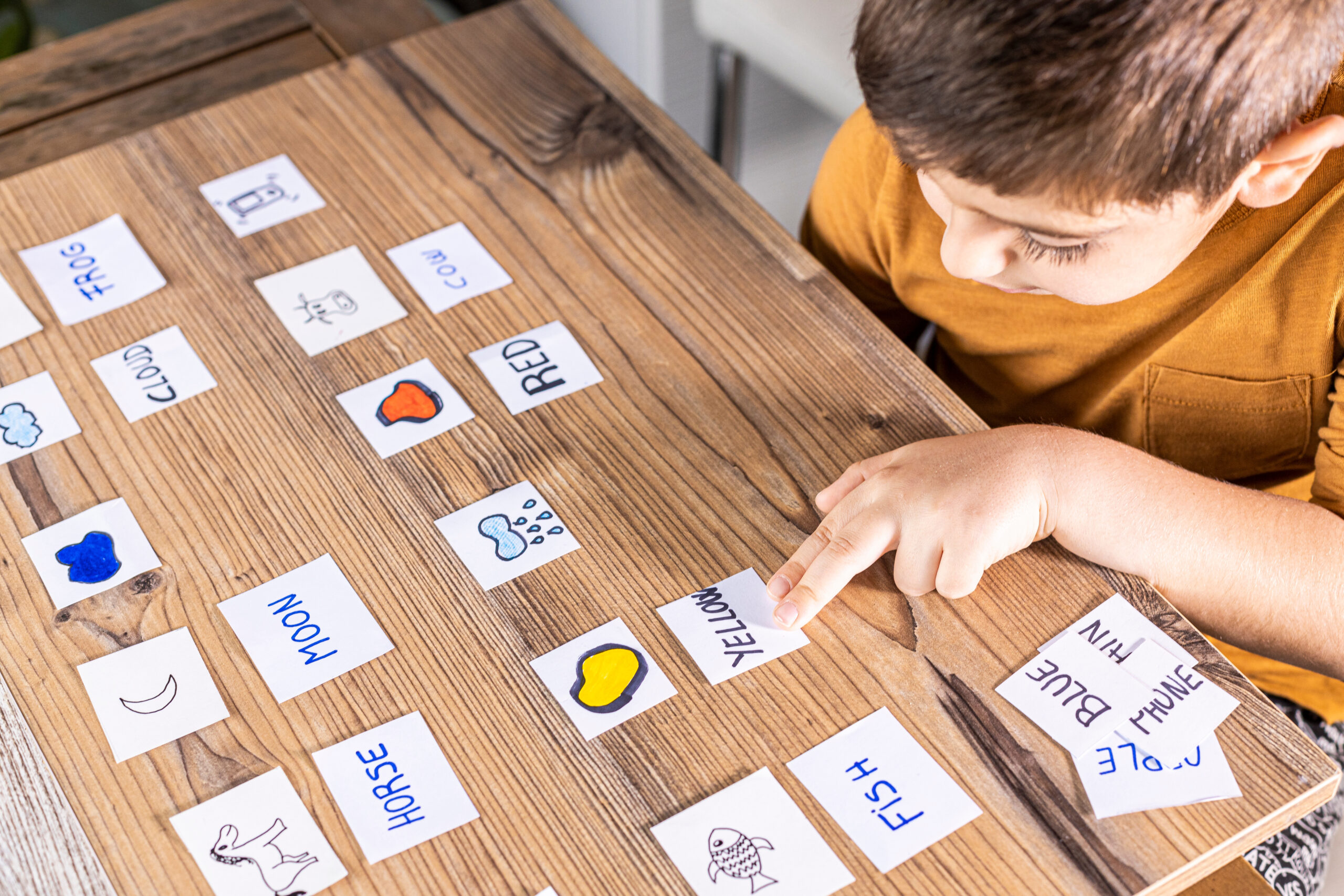 Little kid playing with cards of words and pictures. Little kid playing with cards of words and pictures. Time to learn. Education concept.