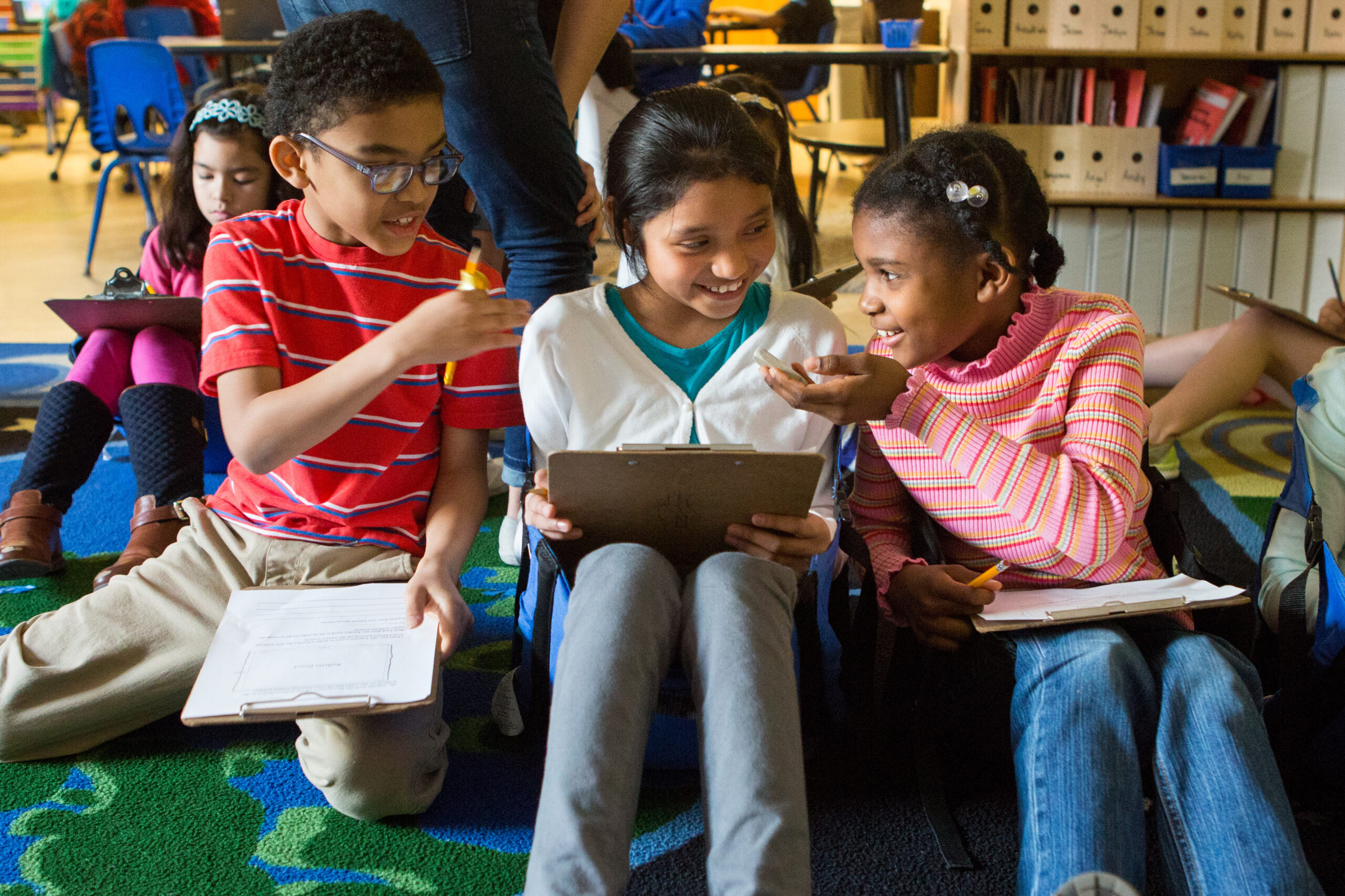 Third graders discuss possible ways to solve a new math problem.